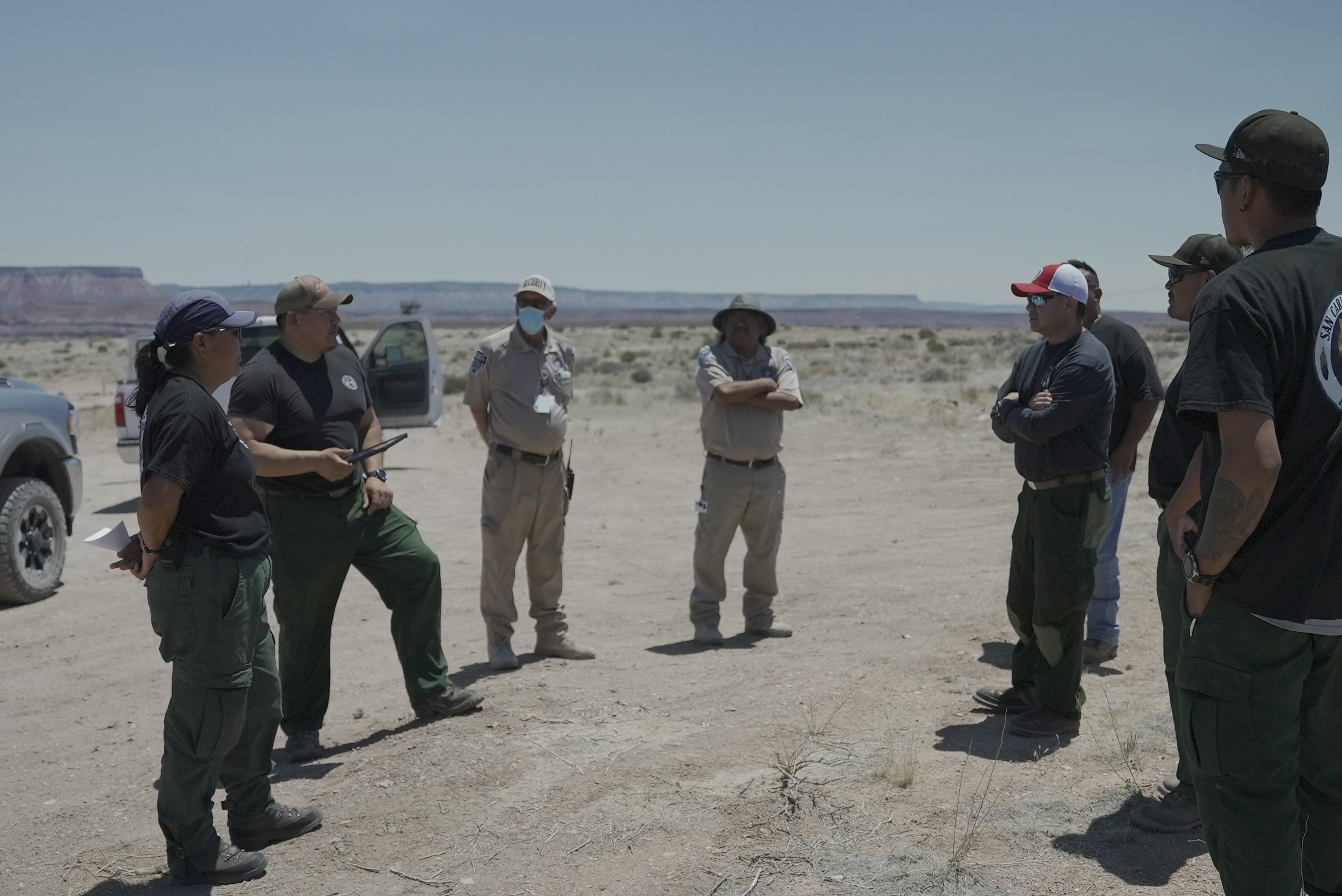 Members of Hualapai Tribe and San Carlos standing in a circle giving a briefing. Photo by BIA