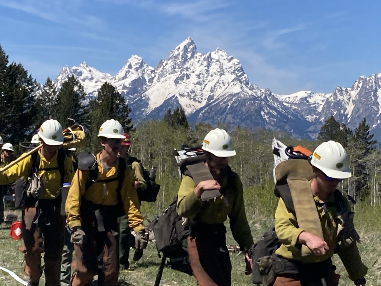 Snake River Hotshots hiking with Tetons in the background.