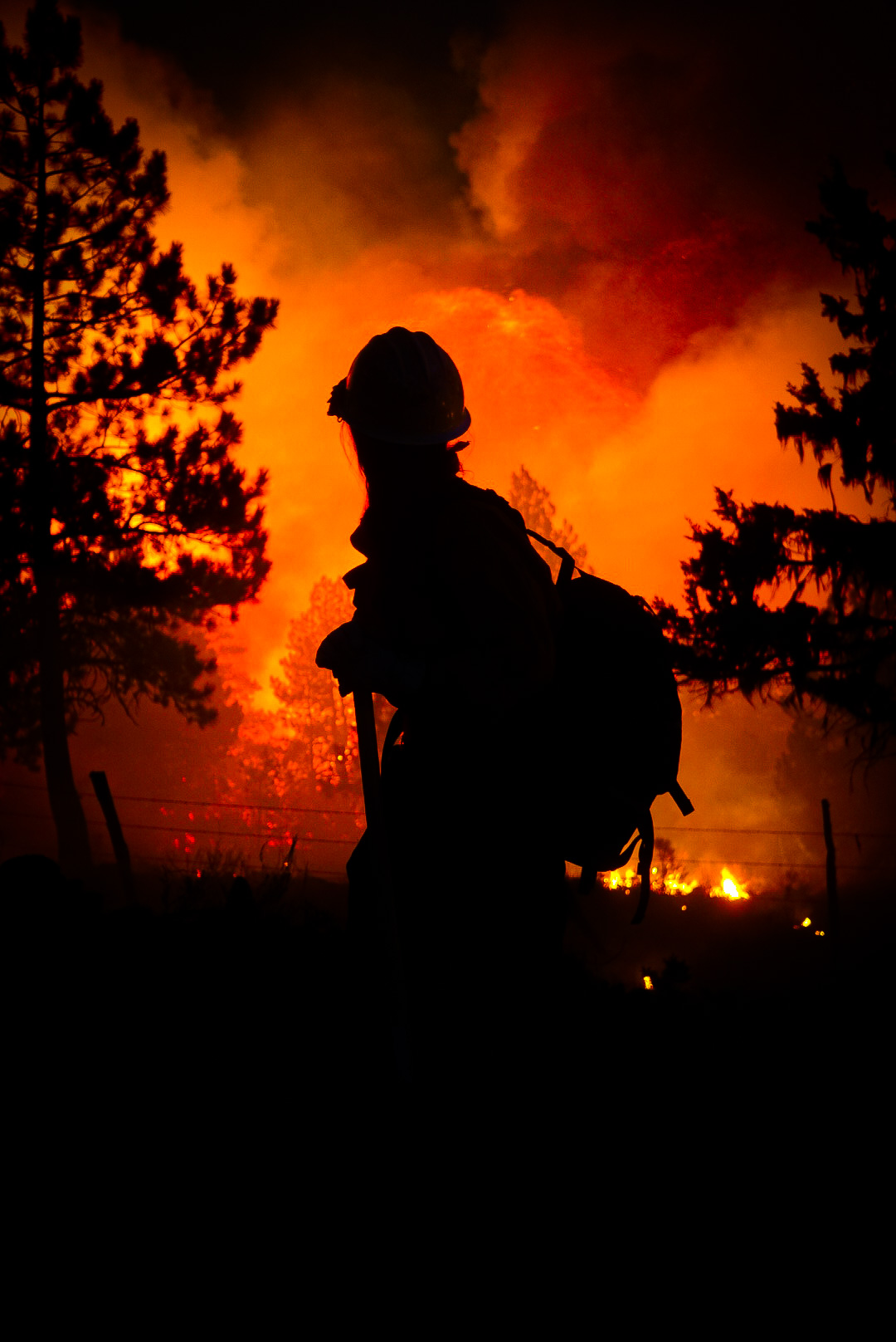 A Medford Crew 10 firefighter monitors a fire at night.