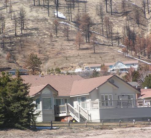 Photo of house with defensible space after fuels treatment