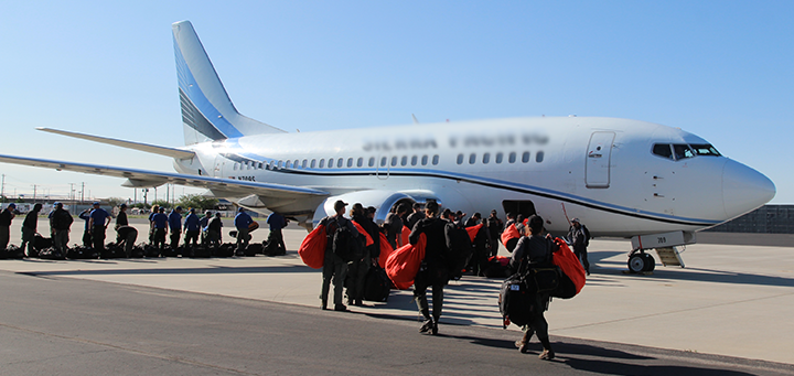 Two USFS hotshot crews board the plane to assist with wildfires in Canada.