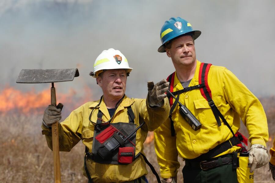 National Park Service firefighters observe a prescribed fire.