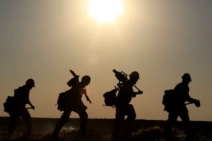 Walking the fireline. BLM wildland firefighters hike the fireline. Photo by BLM.